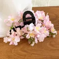 Detail of pink fabric flower hair clip with yellow stamens on wooden background - Claw Clip (38#) / Pink