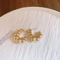 Elegant gold C-shaped chunky hoop earrings with a textured croissant design. - Round C-Shape / Gold