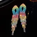 Close-up detail of elegant rainbow gradient rhinestone tassel earrings on dark background - Gradient Colorful Tassel