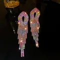 Close-up of elegant long tassel earrings with multi-colored rhinestones on a dark surface - Mixed Gradient Tassel