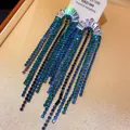 Close-up detail of elegant silver tassel earrings featuring blue and green zircon stones - 10# Silver Needle - Regular - Blue