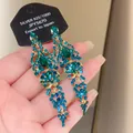 Detailed macro shot of vintage emerald green tassel earrings featuring brilliant zircon crystals. - 22# Silver Pin-Green