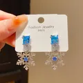 Macro view of vintage style S925 silver snowflake earrings with sparkling blue zircon - 29# Silver Needle - Silver - Blue