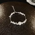Detailed view of a titanium steel bracelet with irregular silver nuggets and pearls. - Bracelet / Silver