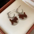 Detail view of vintage flocked rocking horse earrings with sparkling zircons - Silver and Coffee (Semi-Hoop)