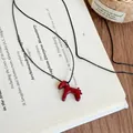 Minimalist red horse pendant necklace with black cord on an open book background - Red Horse Adjustable Black Necklace (7#)