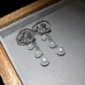 Detailed close-up view of elegant silver oval pearl tassel earrings with pave zircon settings - Oval Rose Pearl Tassel Style (HE31191) / Silver