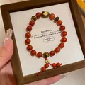 Elegant red agate bead bracelet with gold accents in a premium wooden jewelry box. - Red Agate Tiger Eye Sandalwood Pendant Style(95) / Suspension Box Packaging