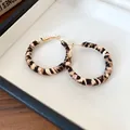 Primer plano de pendientes de aro envueltos en cuero de leopardo con agujas de plata. - Redondo (4mm)