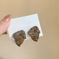 Minimalist irregular brown resin stud earrings with glitter foil on white display card - Brown