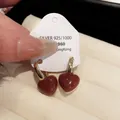 Elegant vintage-style red heart-shaped stud earrings with a gold-tone finish on a display card - Heart Style / Real Gold Plated / Red