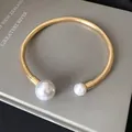 Elegant gold snake chain choker with asymmetrical white faux pearls on grey background. - Asymmetric Double Pearl Choker (23#)