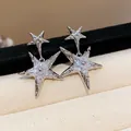 Detailed close-up of sparkling silver star-shaped stud earrings with clear zircon stones - Silver (Silver Pin)