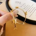Detailed macro shot of elegant golden butterfly hoop earrings featuring s925 silver studs - Butterfly Hoop (Silver Post) / Gold