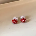 Close-up detail of red star-shaped stud earrings with white polka dots and large pearl beads - 57# Silver Needle - Red - White