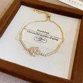 Elegante bracciale in zircone regolabile finitura oro con motivo a quadrifoglio a cuore - Braccialetto a Scorrimento in Zirconia con Cuore e Quadrifoglio (80#) / Oro