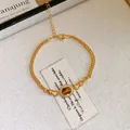 Elegante bracciale dorato con occhio di tigre ovale e aureola di zirconi scintillanti - Stile Occhio di Tigre Ovale (88#) / Marrone oro