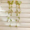 Elegant gold butterfly tassel earrings with green zircon and pearl details. - Gold (Silver Post-Green)