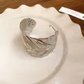 Detailed view of a silver-toned metal cuff bracelet with realistic leaf texture style. - Leaf Texture Style (HB3767) / Silver