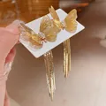 Close-up of golden butterfly tassel earrings with sparkling crystal accents. - Plated-Gold Butterfly (52#)