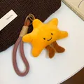 Close-up of yellow plush star pendant with cute smile and woven rope loop - Brown, Yellow