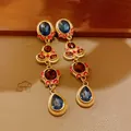 Detailed view of vintage gold earrings with blue and red stones, retro jewelry - Earrings Only (Without Necklace) / Gold