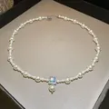 Detailed macro view of a French retro pearl necklace featuring a square blue gemstone pendant. - Blue-White Pendant Style (41#) / White-Blue