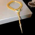 Elegant gold snake necklace with sparkling crystals and green gemstone eye detail - Snake Tassel Necklace / Gold