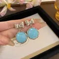 Elegant silver-tone bowknot drop earrings featuring a round light blue gemstone detail - Blue Bowknot Style (48#)