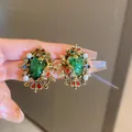 Vintage Baroque gold earrings featuring large green oval gemstones and pearls - Baroque Crown Gemstone Studs