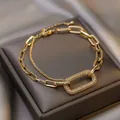 Close-up of retro geometric gold chain bracelet with sparkling pave rhinestone detail - Gold