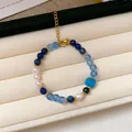 Vintage ethnic style beaded bracelet featuring blue glass and agate beads on cream tray - Vintage Beaded Style (30#) / Blue