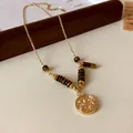 Detailed view of a vintage tiger eye stone necklace with a gold Libra zodiac pendant - Libra Coin Pendant / Gold and Brown (3)
