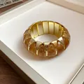 Detailed close-up of a French style geometric marbled acrylic stretch bracelet. - Elastic Geometric Style / Gold Brown