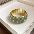 Close-up of French style marbled green acrylic geometric elastic bracelet with gold accents. - Elastic Geometric Style / Gold-Green