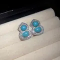 Close-up of silver gourd earrings with turquoise and micro-paved diamonds - Stud Earrings / Silver-Blue