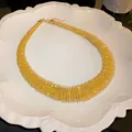 Bold and chunky gold-toned spring coil collar necklace on a white display plate - Gold Style 1 (HN4243) / Gold