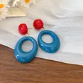 Close-up of retro oval resin drop earrings in red and blue color block design. - Silver Post - Blue - High Quality