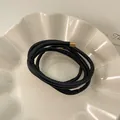 Elegant black leather wrap cord accessory with golden metal end tips - Black