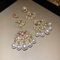 Detailed view of vintage fan-shaped tassel earrings with pearls and rhinestones - Gold