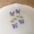Eleganti orecchini a farfalla con glitter viola e accenti di zirconi scintillanti su oro - Farfalla Lunga Glitter Viola (69)