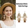 Detailed view of bohemian ethnic style earrings with metal leaves and cotton tassels. - Ear Hook (1#) / Gold-White