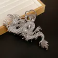 Close-up detail of a silver dragon hair claw clip adorned with sparkling rhinestones and a pearl - Hair Claw Style 2 (HH5035) / Silver