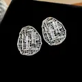 Detail view of luxury gold-plated oval hollow earrings with cubic zirconia inlay. - Oval Hollow Style (HE30145) / 925 Silver Needle / Silver