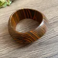Close-up of retro tiger stripe pattern thick bangle bracelet on wooden desk - Style 2