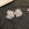 Detail macro view of white frosted petal flower earrings with pearl and gold center - White Flower Earrings (2#)