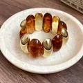 Close-up of a vintage style acrylic tortoise shell bracelet with polished gold oval beads - Bracelet (HB4271) / Dark Coffee
