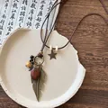Detailed view of a vintage ethnic style necklace with bronze leaf and wood beads - Large Feather Pendant (4#)