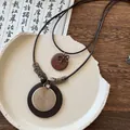 Close-up detail of a vintage ethnic style necklace featuring spiral metal and dark wooden beads - Retro Disc Pendant (5#)