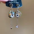 Close-up of bohemian earrings featuring daisy flowers and long crystal tassels - 8# Silver Post Style